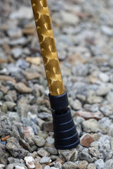 Bottom of a gold chrome effect design on an adjustable walking stick showing ferrule