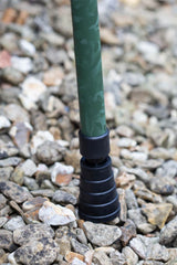 Bottom of green camo adjustable walking stick showing ferrule