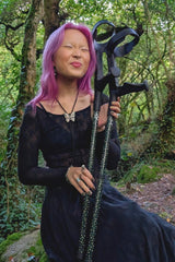 Person holding dark green crutches covered in gold stars from cool Crutches