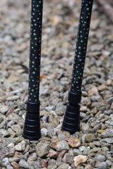 Bottom of dark green crutches covered in gold stars showing ferrules