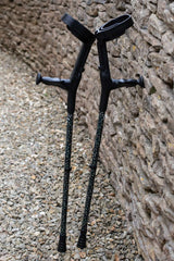 Pair of dark green crutches covered in gold stars