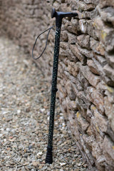 Green adjustable walking stick with a star pattern