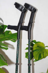 Dark green crutches covered in gold stars from cool Crutches