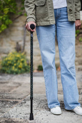 Green adjustable walking stick with a star pattern