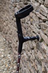 Black crutch with skull and snake design showing cuff