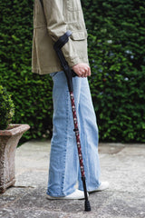 Black crutch with a skull and snakes design