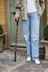 Black crutch with a skull and snakes design