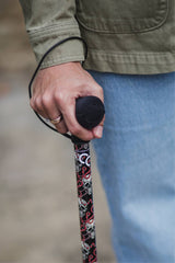 Black walking stick with a skull and snakes design