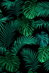 Pattern of green tropical leaves on a black background