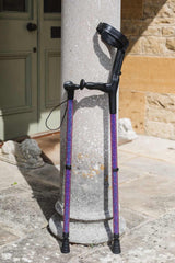Purple Velvet Cool Crutches and Walking Stick Leaning against stone pillar in sunshine