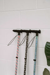 Three Walking Sticks in Funky Prints Leaning Against White Wall