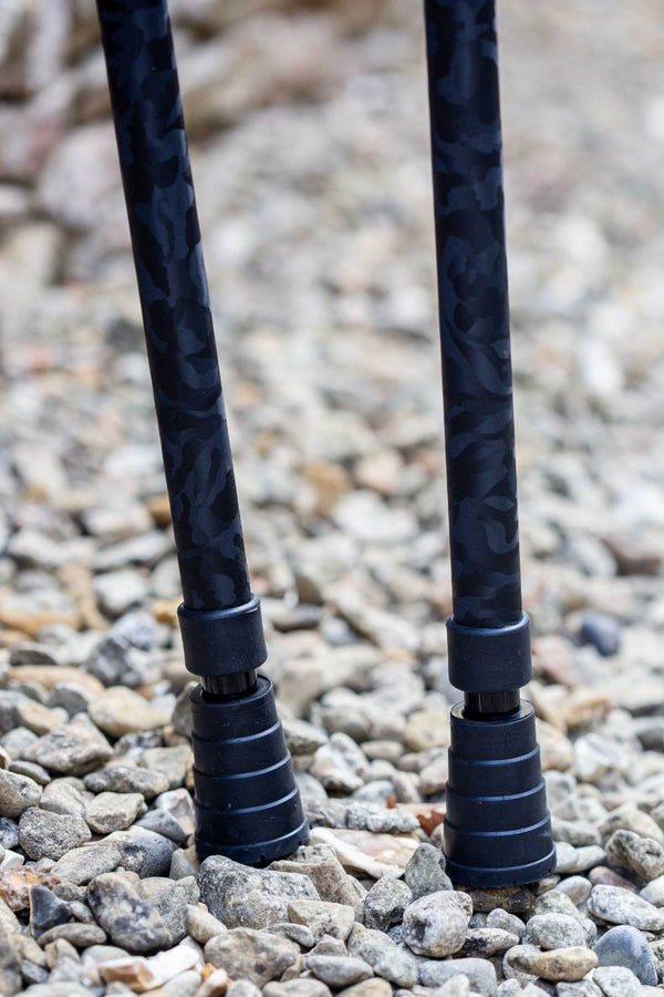 Bottom of black camo designed pair of crutches showing ferrules