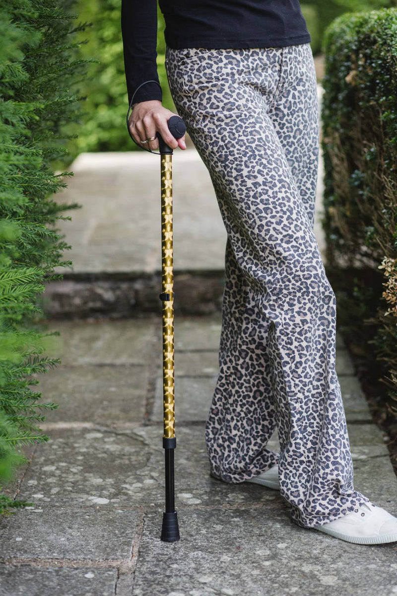 Gold chrome effect design on an adjustable walking stick 
