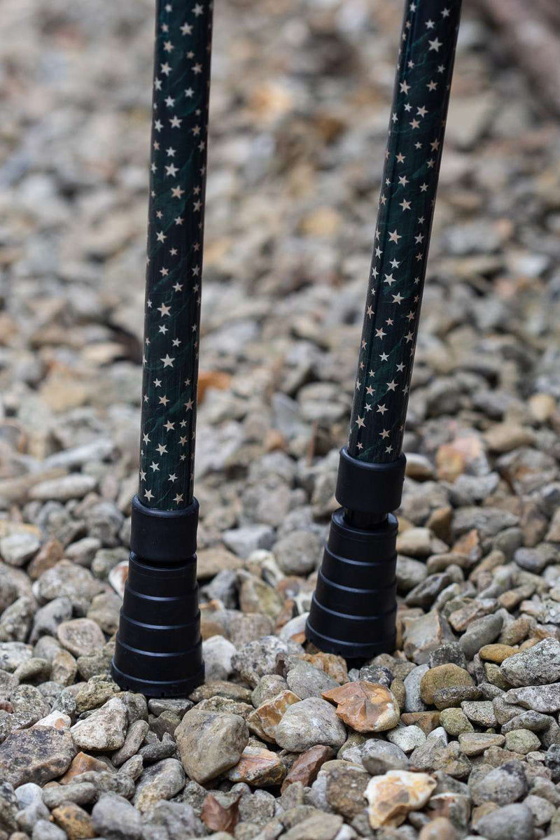 Bottom of dark green crutches covered in gold stars showing ferrules