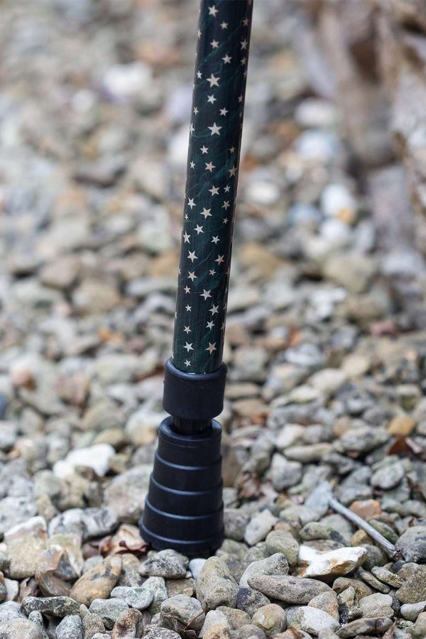 Green adjustable walking stick with a star pattern showing ferrule