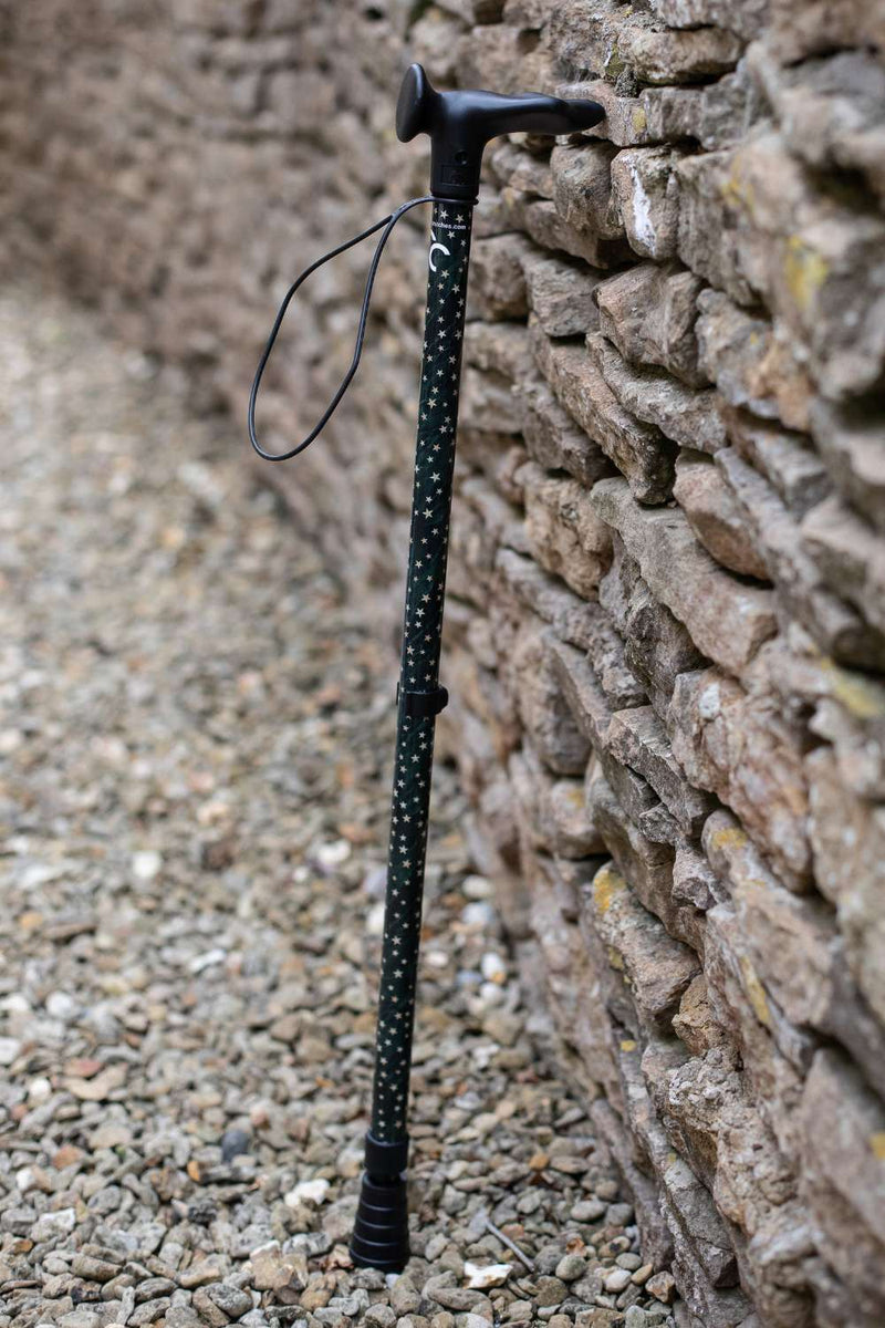 Green adjustable walking stick with a star pattern 