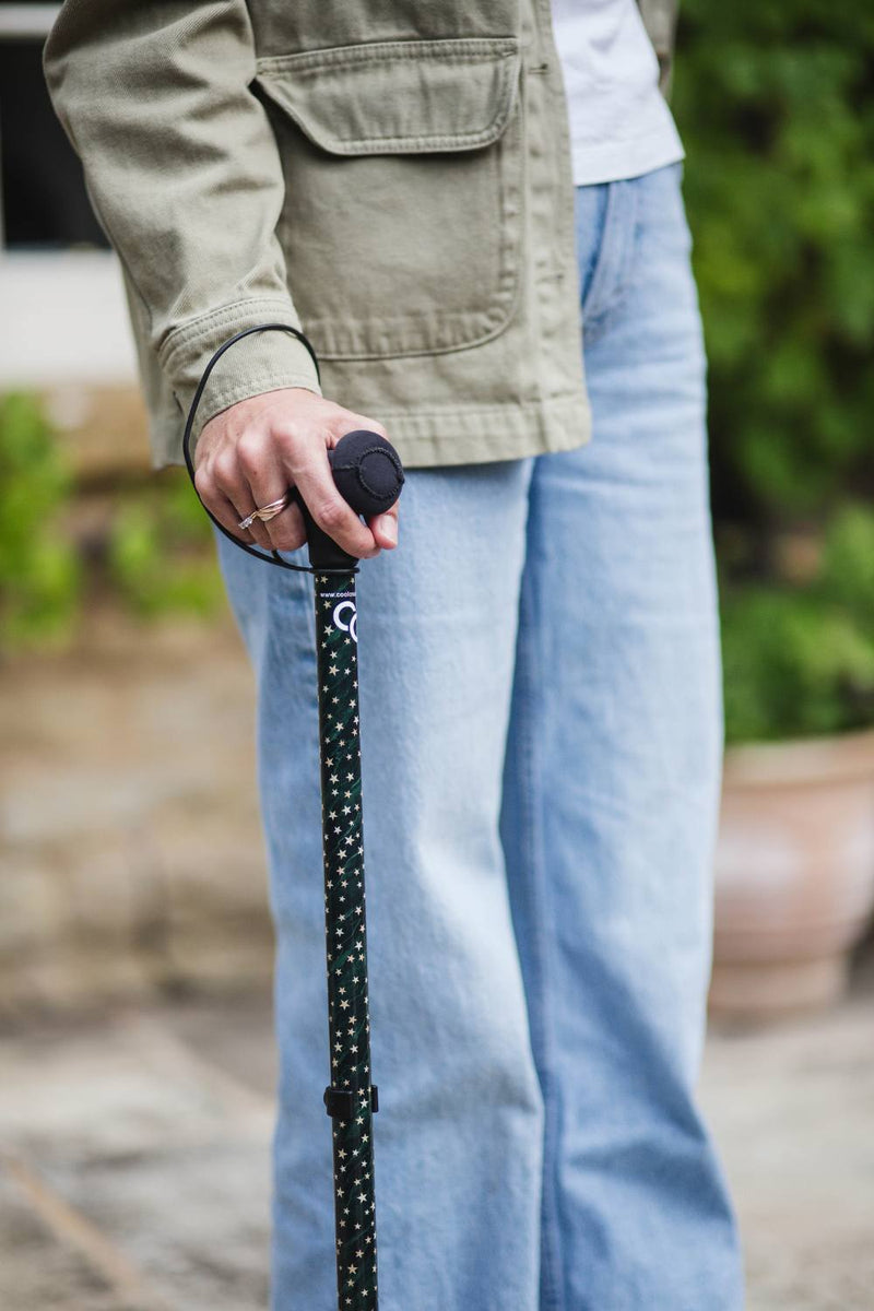 Green adjustable walking stick with a star pattern 