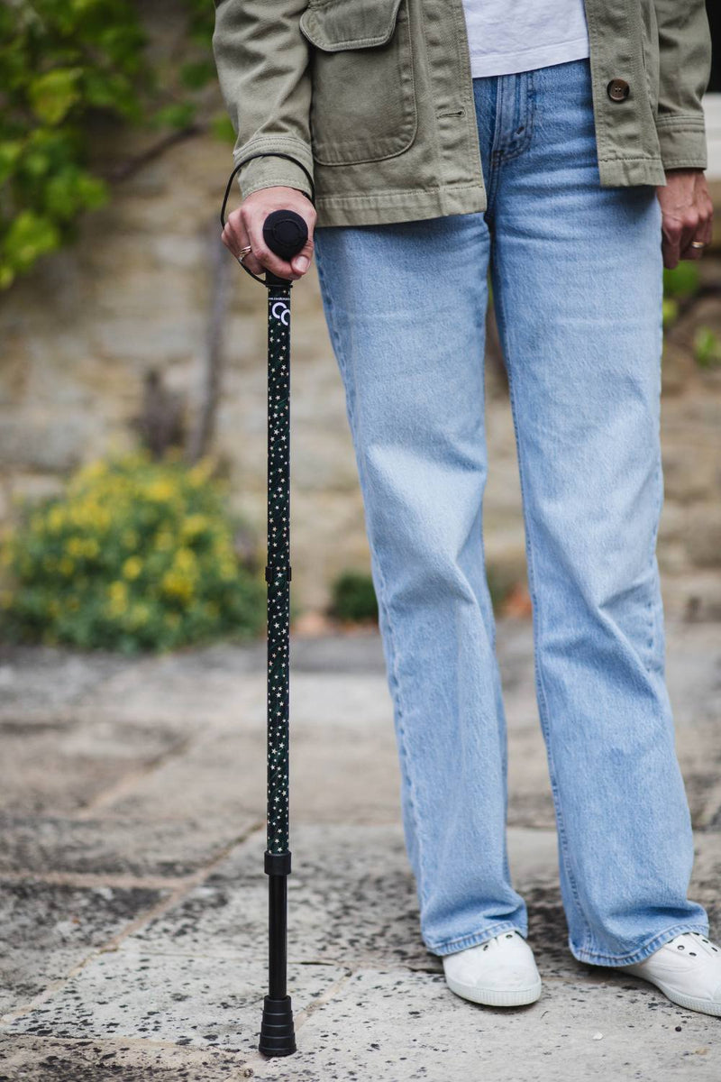 Green adjustable walking stick with a star pattern 