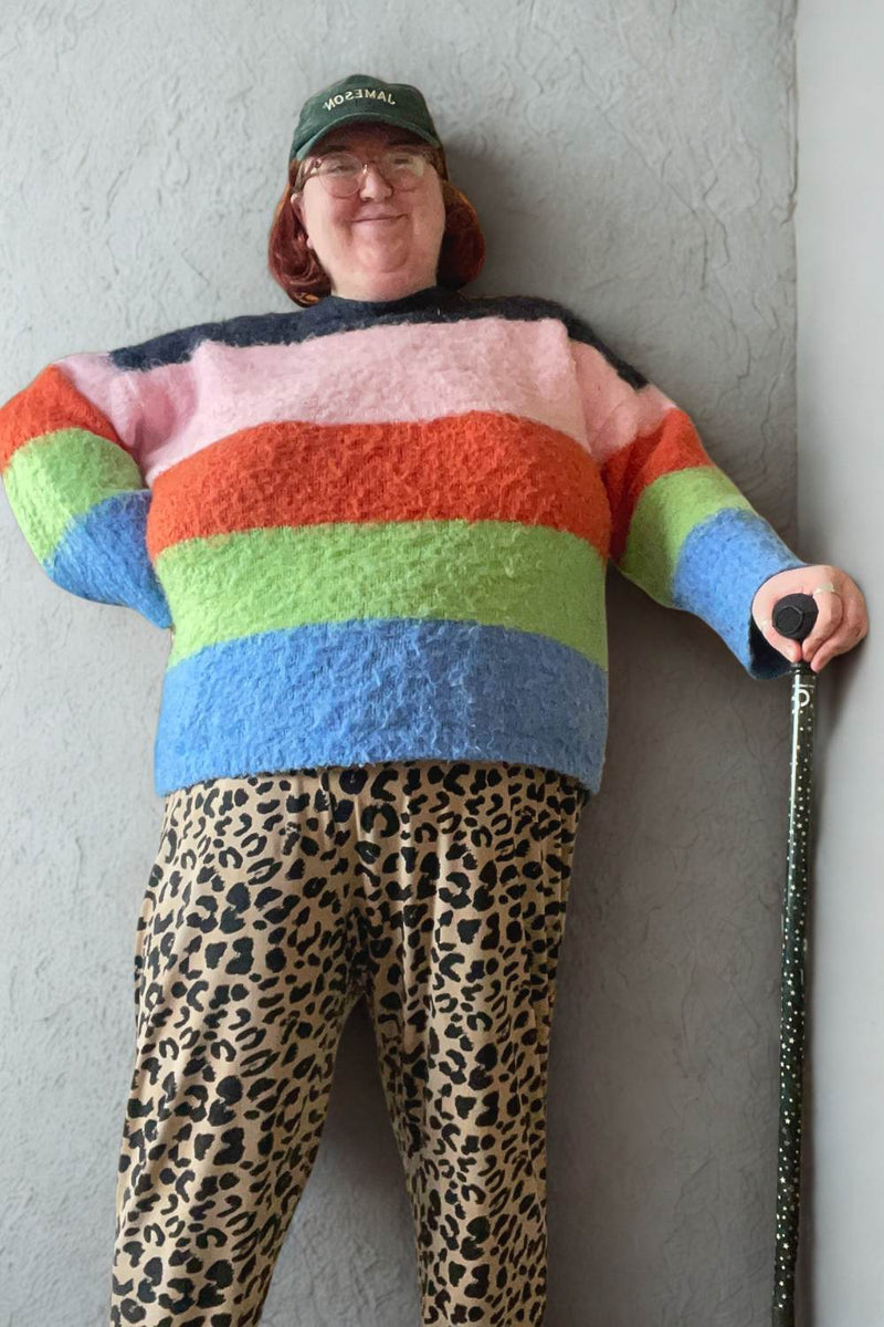 Person with a green adjustable walking stick with a star pattern 