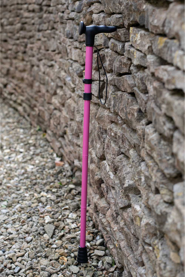 Pink folding walking stick by cool crutches with ergonomic handle, soft grip cover and ferrule