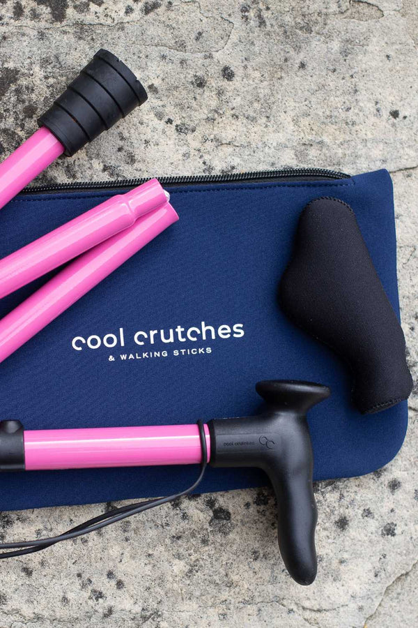 Pink folding walking stick by cool crutches with ergonomic handle, soft grip cover and neoprene travel bag