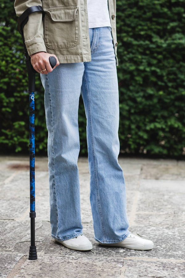 A pair of crutches designed with deep ocean blues and streaks of gold lightning