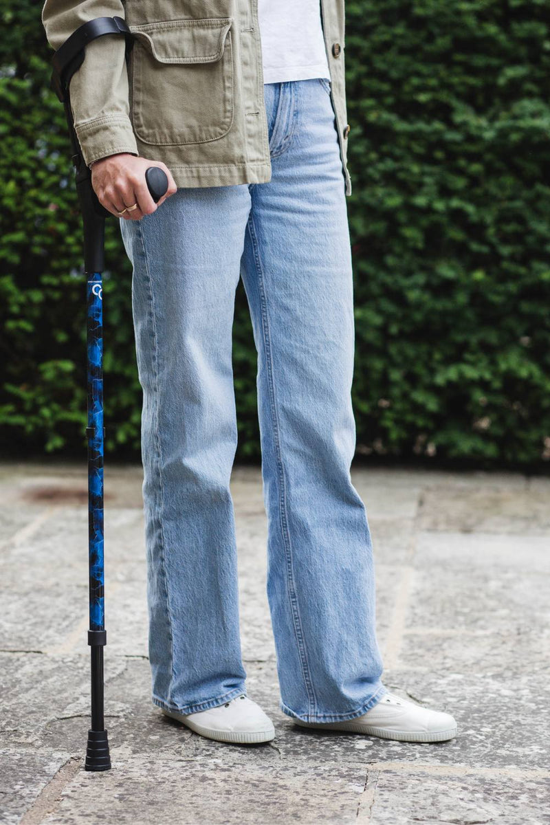 A pair of crutches designed with deep ocean blues and streaks of gold lightning