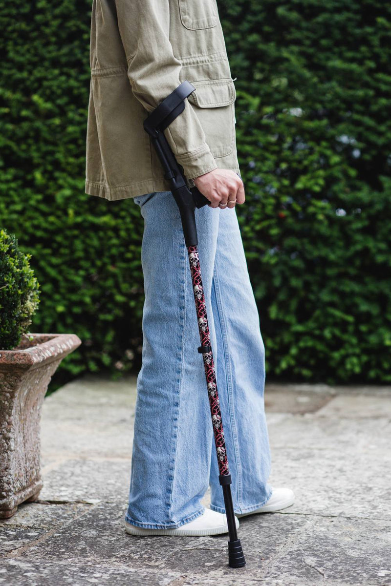 Black crutch with a skull and snakes design