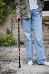 Black walking stick with a skull and snakes design