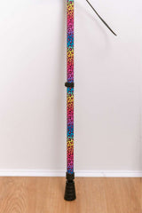 Colorful leopard print walking stick on a white background