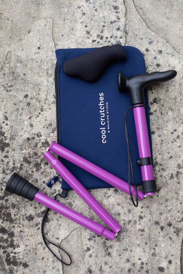 Purple folding walking stick by cool crutches with ergonomic handle, soft grip cover and neoprene travel bag