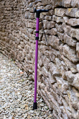 Purple folding walking stick by cool crutches with ergonomic handle and wrist strap
