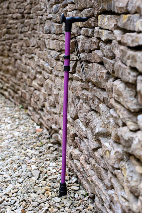 Purple folding walking stick by cool crutches with ergonomic handle and wrist strap
