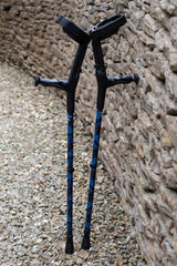 A pair of crutches designed with deep ocean blues and streaks of gold lightning