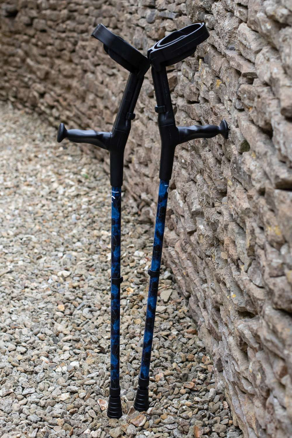 A pair of crutches designed with deep ocean blues and streaks of gold lightning