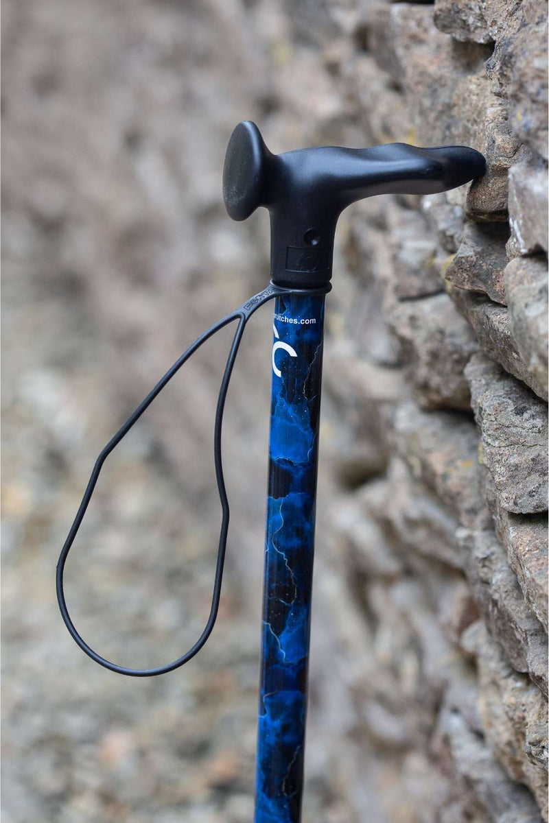 A walking stick with a blend of deep ocean blues and electric gold lightning streaks showing the moulded handle