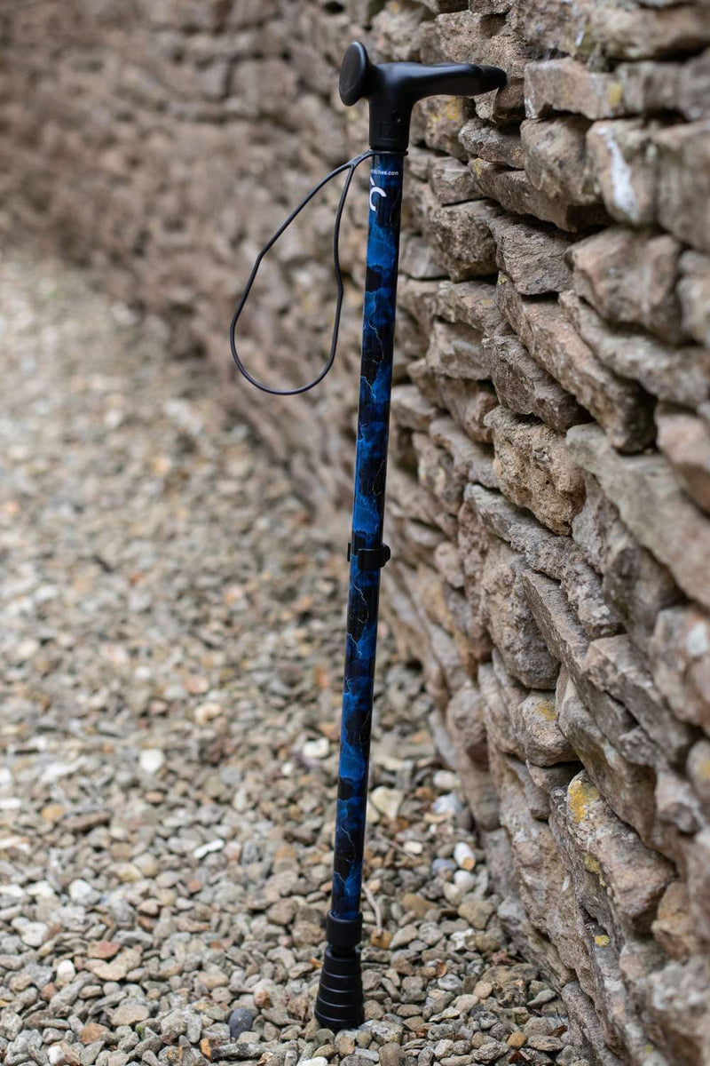 A walking stick with a blend of deep ocean blues and electric gold lightning streaks