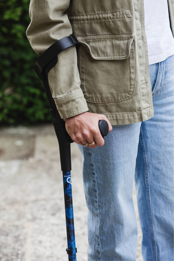A pair of crutches designed with deep ocean blues and streaks of gold lightning