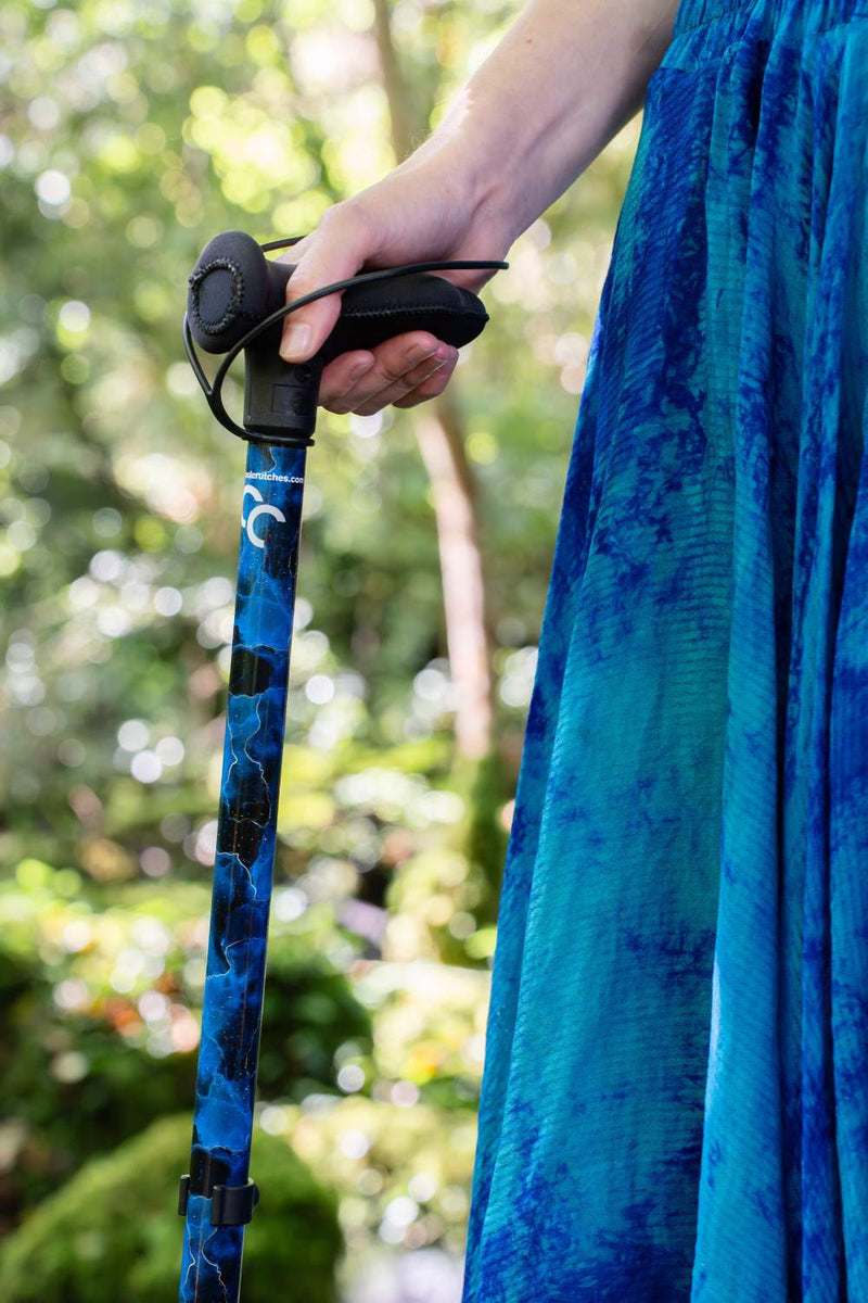 walking stick with a blend of deep ocean blues and electric gold lightning streaks  from Cool Crutches
