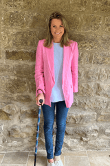 Co Founder of Cool Crutches Amelia Wears Funky Purple Walking Stick with Pink Jacket and Jeans